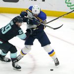 Seattle Kraken's Vince Dunn (29) and St. Louis Blues' Brandon Saad collide as they go for the puck in the second period of an NHL hockey game Friday, Jan. 21, 2022, in Seattle. (AP Photo/Elaine Thompson)