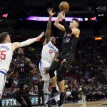 
              Miami Heat guard Tyler Herro (14) goes to the basket and Los Angeles Clippers center Isaiah Hartenstein (55) and guard Eric Bledsoe (12) defend during the first half of an NBA basketball game, Friday, Jan. 28, 2022, in Miami. (AP Photo/Lynne Sladky)
            
