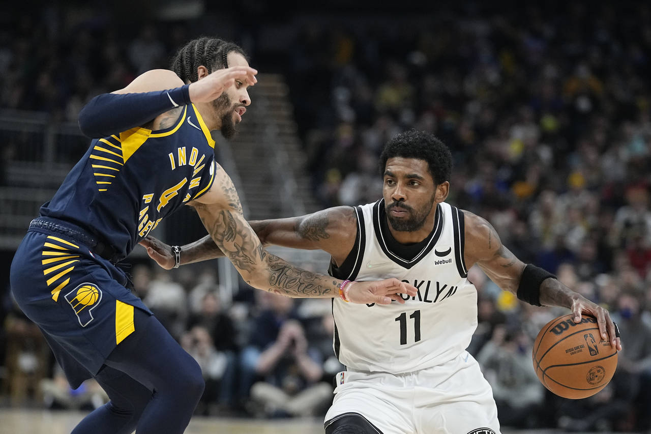 Brooklyn Nets' Kyrie Irving (11) is defended by Indiana Pacers' Duane Washington Jr. (4) during the...