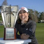 
              Danielle Kang poses next to the championship trophy on the 18th green after winning the Tournament of Champions LPGA golf tournament, Sunday, Jan. 23, 2022, in Orlando, Fla. (AP Photo/Phelan M. Ebenhack)
            