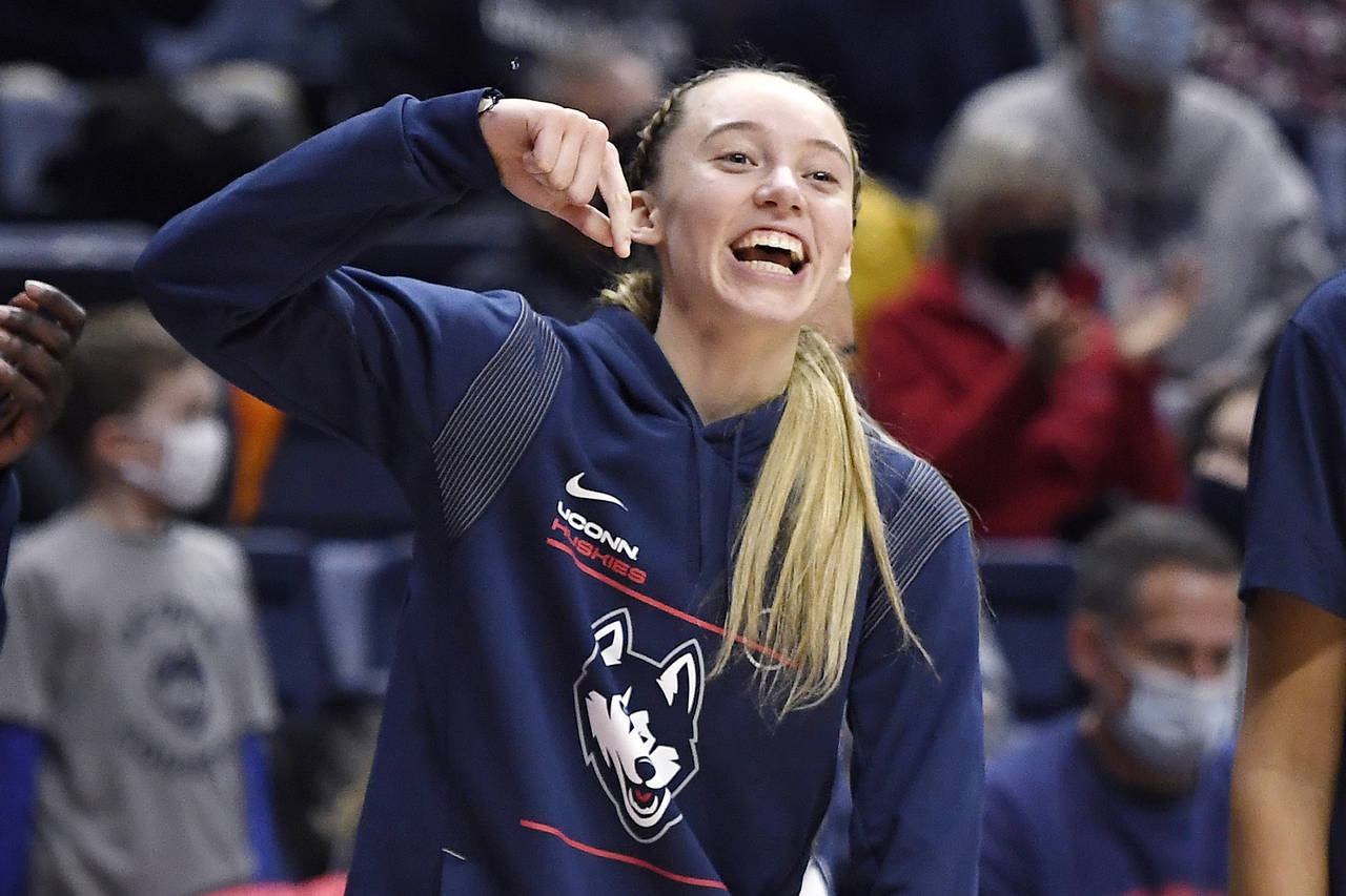 Connecticut's Paige Bueckers reacts after teammates Caroline Ducharme blocked a shot against Creigh...