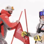 
              Visar Kryeziu, a photographer with The Associated Press and father of Kiana Kryeziu, right, fixes flags as he sets a ski course during training at the Arxhena Ski center in Dragas, Kosovo on Saturday, Jan. 22, 2022. The 17-year-old Kryeziu is the first female athlete from Kosovo at the Olympic Winter Games after she met the required standards, with the last races held in Italy. (AP Photo)
            
