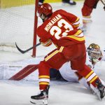 
              Florida Panthers goalie Spencer Knight watches as Calgary Flames' Sean Monahan scores during the third period of an NHL hockey game Tuesday, Jan. 18, 2022, in Calgary, Alberta. (Jeff McIntosh/The Canadian Press via AP)
            