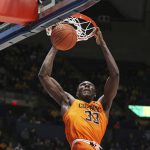 
              Oklahoma State forward Moussa Cisse (33) dunks against West Virginia during the first half of an NCAA college basketball game in Morgantown, W.Va., Tuesday, Jan. 11, 2022. (AP Photo/Kathleen Batten)
            