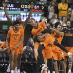 
              Oklahoma State guard Bryce Thompson is lifted up by teammates following their win over No. 1 Baylor in an NCAA college basketball game, Saturday, Jan. 15, 2022, in Waco, Texas. (Rod Aydelotte/Waco Tribune-Herald via AP)
            