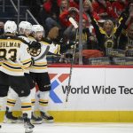 
              Boston Bruins defenseman Matt Grzelcyk, right, celebrates his goal with left wing Anton Blidh (81) and center Karson Kuhlman (83) during the second period of an NHL hockey game against the Washington Capitals, Monday, Jan. 10, 2022, in Washington. (AP Photo/Nick Wass)
            