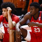 
              Mississippi guard James White (5) and Sammy Hunter (23) watch the final seconds of the team's NCAA college basketball game against Tennessee on Wednesday, Jan. 5, 2022, in Knoxville, Tenn. Tennessee won 66-60 in overtime. (AP Photo/Wade Payne)
            