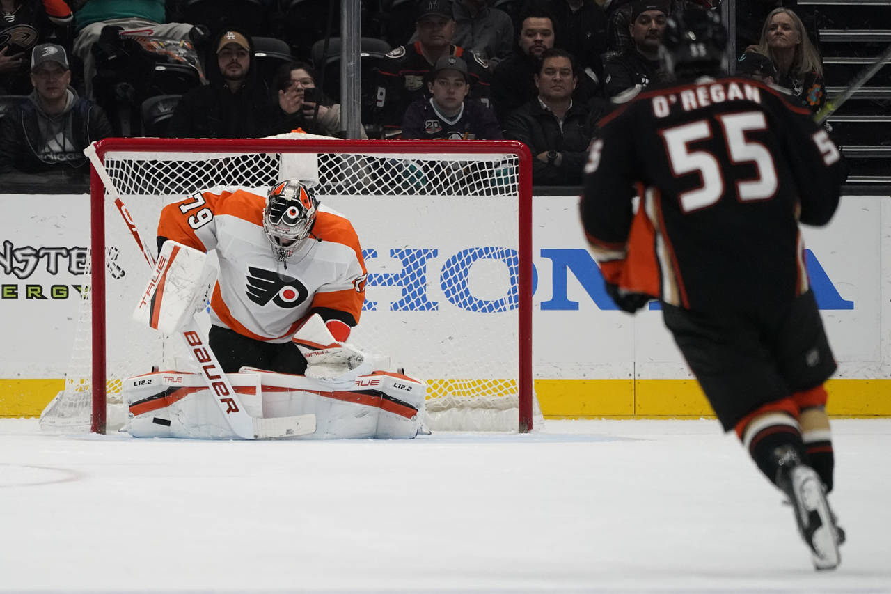 Philadelphia Flyers goaltender Carter Hart (79) blocks a shot from Anaheim Ducks center Danny O'Reg...