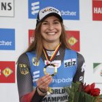 
              Julia Taubitz of Germany celebrates on podium after winning the women's single-seater competition of the Luge World Cup in Winterberg, Germany, Sunday, Jan. 2, 2022. (Friso Gentsch/dpa via AP)
            