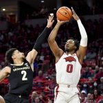 
              Arkansas guard Stanley Umude (0) shoots a three pointer over Vanderbilt guard Scotty Pippen Jr. (2) during the first half of an NCAA college basketball game Tuesday, Jan. 4, 2022, in Fayetteville, Ark. (AP Photo/Michael Woods)
            