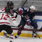 
              FILE - United States' Kendall Coyne Schofield (26) looks to pass as Canada's Meaghan Mikkelson (12) defends during the first period of a women's exhibition hockey game ahead of the Beijing Olympics Wednesday, Dec. 15, 2021, in Maryland Heights, Mo. The United States is the defending Olympic champion after beating Canada in an exceptionally nail-biting 3-2 shootout win at South Korea in 2018 to end Canada's run of four gold medals. And yet, Canada is the reigning world champion after punching back with a 3-2 overtime gold-medal win in Calgary, Alberta, in August to end USA's run of five consecutive titles. (AP Photo/Jeff Roberson, File)
            