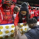 
              Georgia defensive tackle Jordan Davis, bottom right, prays with his mother Shay Allen before playing Alabama in the College Football Playoff championship game Monday, Jan. 10, 2022, in Indianapolis. (Curtis Compton/Atlanta Journal-Constitution via AP)
            