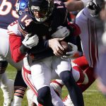 
              Chicago Bears quarterback Andy Dalton is sacked by New York Giants outside linebacker Lorenzo Carter during the first half of an NFL football game Sunday, Jan. 2, 2022, in Chicago. (AP Photo/David Banks)
            