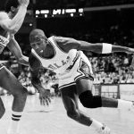 
              FILE - Chicago Bulls' Michael Jordan drives past Washington Bullets' Dudley Bradley during NBA action in Chicago, on Oct. 26, 1984. (AP Photo/Fred Jewell, File)
            
