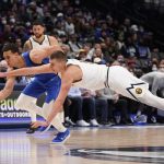 
              Denver Nuggets center Nikola Jokic (15) reaches for the ball against Dallas Mavericks center Dwight Powell (7) during the first half of an NBA basketball game in Dallas, Monday, Jan. 3, 2022. (AP Photo/LM Otero)
            