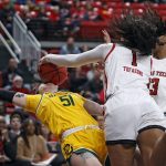 
              Texas Tech's Ella Tofaeono (1) fouls Baylor's Caitlin Bickle (51) by hitting the ball in her face during the first half of an NCAA college basketball game on Wednesday, Jan. 26, 2022, in Lubbock, Texas. (AP Photo/Brad Tollefson)
            