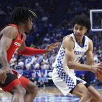 
              Kentucky's Jacob Toppin (0) looks for an opening as Georgia's Kario Oquendo (3) defends during the first half of an NCAA college basketball game in Lexington, Ky., Saturday, Jan. 8, 2022. (AP Photo/James Crisp)
            