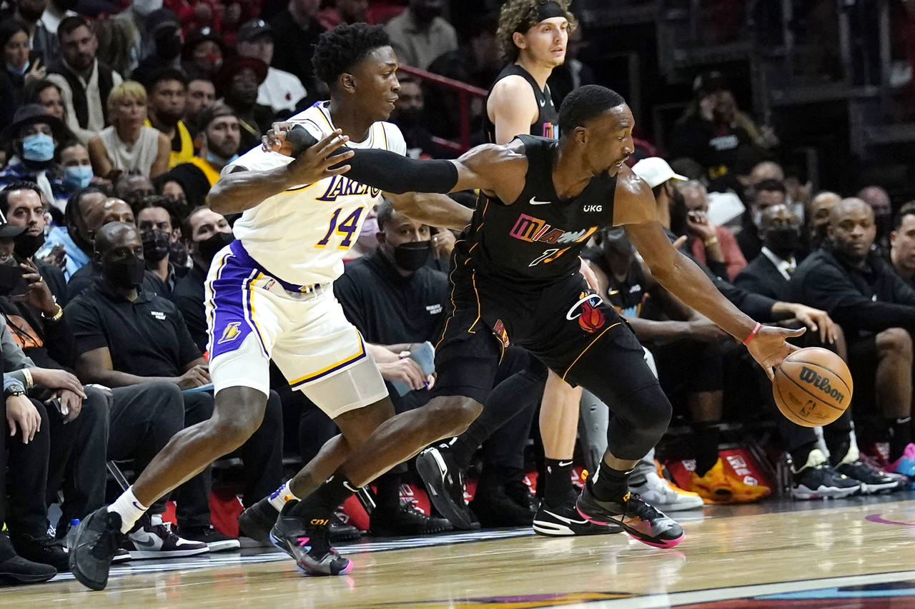 Miami Heat center Bam Adebayo (13) drives to the basket as Los Angeles Lakers forward Stanley Johns...