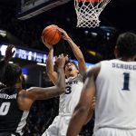 
              Xavier guard Colby Jones (3) is fouled by Providence's Ed Croswell (5) during the first half of an NCAA college basketball game, Wednesday, Jan. 26, 2022, in Cincinnati. (AP Photo/Jeff Dean)
            