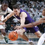 
              Northwestern's Ryan Greer, center, Michigan State's Gabe Brown, left, and Northwestern's A.J. Hoggard, right, vie for the ball during the first half of an NCAA college basketball game, Saturday, Jan. 15, 2022, in East Lansing, Mich. (AP Photo/Al Goldis)
            