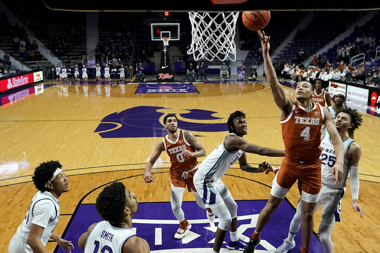 Texas forward Dylan Disu (4) shoots during the first half of an NCAA college basketball game agains...