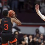 
              Miami's Charlie Moore (3) shoots the winning basket from midcourt past Virginia Tech's Storm Murphy (5) at the buzzer to end second half of an NCAA college basketball game, Wednesday, Jan. 26 2022, in Blacksburg Va. (Matt Gentry/The Roanoke Times via AP)
            