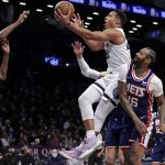 
              Memphis Grizzlies guard Desmond Bane, center, drives to the basket past Brooklyn Nets forward James Johnson (16) during the first half of an NBA basketball game Monday, Jan. 3, 2022, in New York. (AP Photo/Adam Hunger)
            