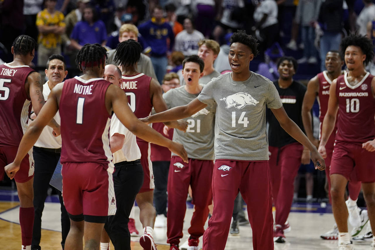 Arkansas celebrates after defeating LSU in an NCAA college basketball game in Baton Rouge, La., Sat...
