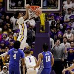 
              LSU forward Alex Fudge (3) dunks over Kentucky forward Daimion Collins (4) and guard Davion Mintz (10) in the first half of an NCAA college basketball game in Baton Rouge, La., Tuesday, Jan. 4, 2022. (AP Photo/Derick Hingle)
            