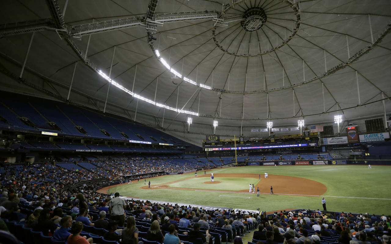FILE - The Houston Astros play the Texas Rangers during the third inning of a baseball game at Trop...