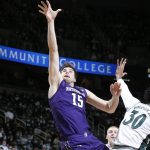 
              Northwestern's Ryan Young, left, shoots against Michigan State's Marcus Bingham Jr. (30) during the first half of an NCAA college basketball game, Saturday, Jan. 15, 2022, in East Lansing, Mich. Northwestern won 64-62. (AP Photo/Al Goldis)
            