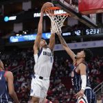 
              Dallas Mavericks guard Josh Green (8) dunks as Houston Rockets center Christian Wood, right, defends during the first half of an NBA basketball game Friday, Jan. 7, 2022, in Houston. (AP Photo/Eric Christian Smith)
            