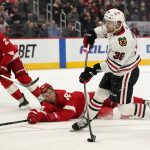 
              Chicago Blackhawks left wing Brandon Hagel (38) shoots against the Detroit Red Wings in the third period of an NHL hockey game Wednesday, Jan. 26, 2022, in Detroit. (AP Photo/Paul Sancya)
            