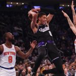 
              Sacramento Kings' Tyrese Haliburton, center, is fouled by New York Knicks' Evan Fournier, right, while driving to the basket during the first half of an NBA basketball game, Monday, Jan. 31, 2022, in New York. (AP Photo/Seth Wenig)
            