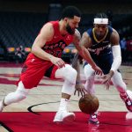 
              Toronto Raptors guard Fred VanVleet (23) and New Orleans Pelicans guard Devonte' Graham (4) battle for the ball during second-half NBA basketball game action in Toronto, Sunday, Jan. 9, 2022. (Frank Gunn/The Canadian Press via AP)
            