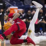 
              North Carolina State's Breon Pass, left, competes for a loose ball with Notre Dame's Prentiss Hubb during the first half of an NCAA college basketball game Wednesday, Jan. 26, 2022, in South Bend, Ind. (AP Photo/Robert Franklin)
            
