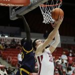 Washington State forward Andrej Jakimovski, right, shoots in front of California forward Kuany Kuany during the second half of an NCAA college basketball game, Saturday, Jan. 15, 2022, in Pullman, Wash. (AP Photo/Young Kwak)