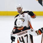 
              DUE TO A CHANGE BY THE OFFICIAL SCORER, CORRECTS TO SAY THAT GETZLAF WAS CREDITED WITH AN ASSIST AND THE GOAL WAS CREDITED TO DEREK GRANT - Anaheim Ducks center Ryan Getzlaf, top, is congratulated by defenseman Hampus Lindholm (47) after Getzlaf's assist on a goal by teammate Derek Grant against the Boston Bruins during the first period of an NHL hockey game, Monday, Jan. 24, 2022, in Boston. (AP Photo/Charles Krupa)
            