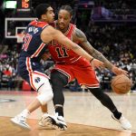 
              Chicago Bulls forward DeMar DeRozan (11) drives to the basket against Washington Wizards guard Tremont Waters (51) during the first half of an NBA basketball game, Saturday, Jan. 1, 2022, in Washington. (AP Photo/Nick Wass)
            