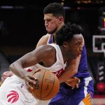 
              Toronto Raptors forward OG Anunoby (3) tries to get past Phoenix Suns guard Devin Booker (1) during the second half of an NBA basketball in Toronto on Tuesday, Jan. 11, 2022. (Frank Gunn/The Canadian Press via AP)
            
