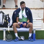 
              Serbia's Novak Djokovic sits on a bench as he trains on a tennis court in Marbella, Spain, on Jan. 2, 2022. Djokovic held a practice session on Tuesday, Jan. 11, a day after he left immigration detention, focusing on defending his Australian Open. There were also new questions raised Tuesday over an immigration form, on which he said he had not traveled in the 14 days before his flight to Australia. The Monte Carlo-based athlete was seen in Spain and Serbia in that two-week period. (KMJ/GTRES via AP)
            