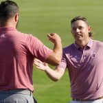 
              Cameron Smith, right, greets Jon Rahm, of Spain, after Smith won the Tournament of Champions golf event, Sunday, Jan. 9, 2022, at Kapalua Plantation Course in Kapalua, Hawaii. (AP Photo/Matt York)
            