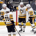 
              Pittsburgh Penguins forward Jake Guentzel (59), forward Evgeni Malkin (71), forward Sidney Crosby (87) and forward Bryan Rust (17) celebrate Crosby's second goal of the night against the Columbus Blue Jackets, during the third period of an NHL hockey game in Columbus, Ohio, Friday, Jan. 21, 2022. The Penguins won 5-2. (AP Photo/Paul Vernon)
            