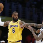 
              Los Angeles Lakers forward LeBron James (6) is defended by Utah Jazz guard Jordan Clarkson, right, during the first half of an NBA basketball game in Los Angeles, Monday, Jan. 17, 2022. (AP Photo/Ringo H.W. Chiu)
            