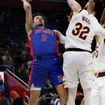 
              Detroit Pistons guard Cade Cunningham (2) takes a shot against Cleveland Cavaliers forward Dean Wade (32) during the first half of an NBA basketball game Sunday, Jan. 30, 2022, in Detroit. (AP Photo/Duane Burleson)
            