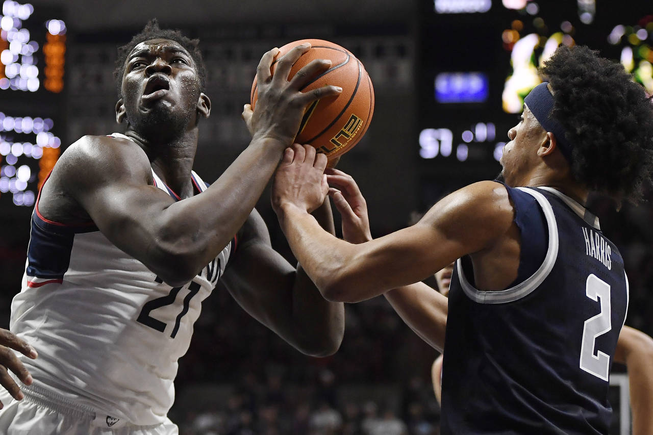 Connecticut's Adama Sanogo goes up to the basket as Georgetown's Dante Harris (2) defends in the se...