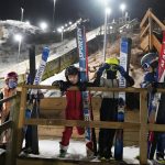 
              Kids wait their turn at the 10-meter ski jump, as a teenager slides down the 25-meter jump, background, Tuesday, Jan. 18, 2022, at the Norge Ski Club in Fox River Grove, Ill. For the second straight winter games, the club has produced three men who will represent the United States in China. (AP Photo/Charles Rex Arbogast)
            