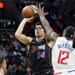 
              Miami Heat guard Tyler Herro (14) goes to the basket as Los Angeles Clippers guard Eric Bledsoe (12) defends during the first half of an NBA basketball game, Friday, Jan. 28, 2022, in Miami. (AP Photo/Lynne Sladky)
            
