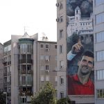 
              FILE - A billboard depicting Serbian tennis player Novak Djokovic and the Christian Orthodox monastery of Ostrog is seen on a building in Belgrade, Serbia, June 24, 2020. In Serbia, Djokovic is revered as a national hero who overcame the odds in the economically crippled country with few tennis courts to become the world’s No. 1 player. (AP Photo/Darko Vojinovic, File)
            