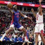 
              Detroit Pistons' Saddiq Bey (41) passes past the out stretched arm of Chicago Bulls' Tony Bradley during the first half of an NBA basketball game Tuesday, Jan. 11, 2022, in Chicago. (AP Photo/Charles Rex Arbogast)
            